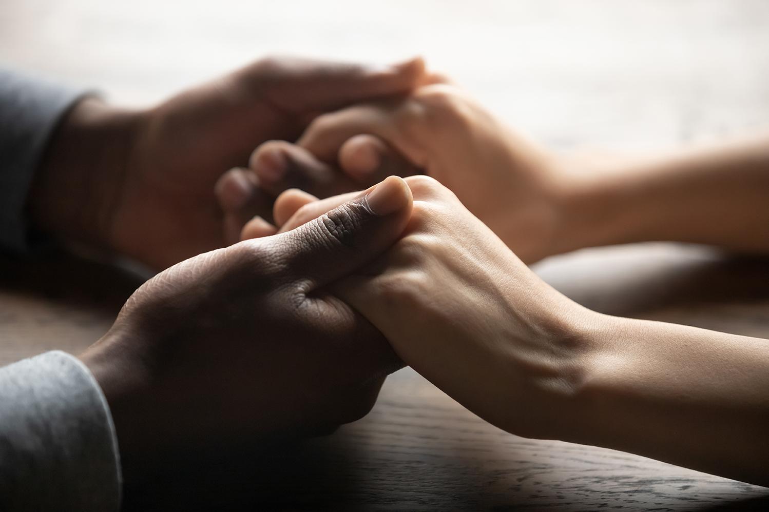 Image of two people holding hands